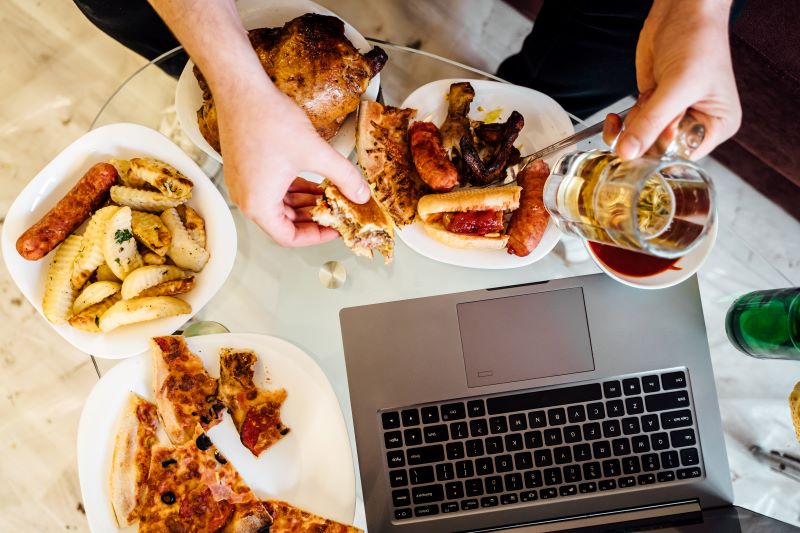 tuczące jedzenie i alkohol przed laptopem