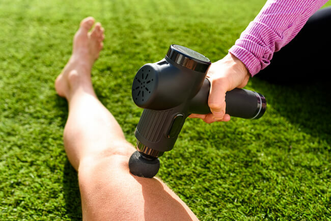 Leg massage with a gun massager